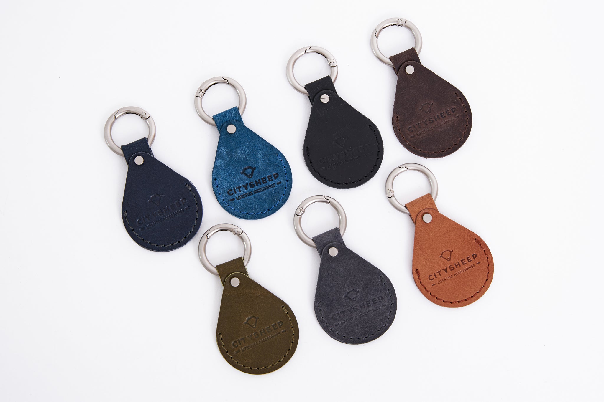 Handcrafted leather AirTag holder in different colors: blue, black, brown, green, grey.