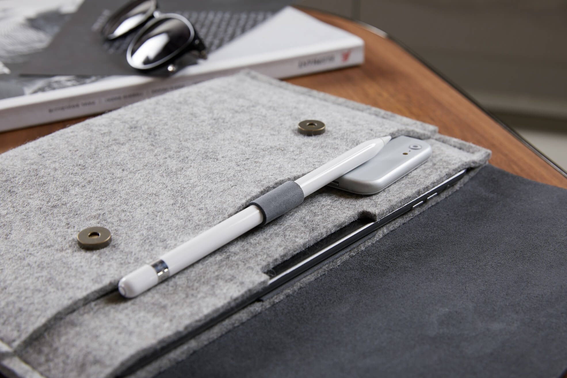 Handcrafted iPad case with Apple pencil holder and magnetic closure. Fits charger, accessories. Made from wool felt and full grain leather.