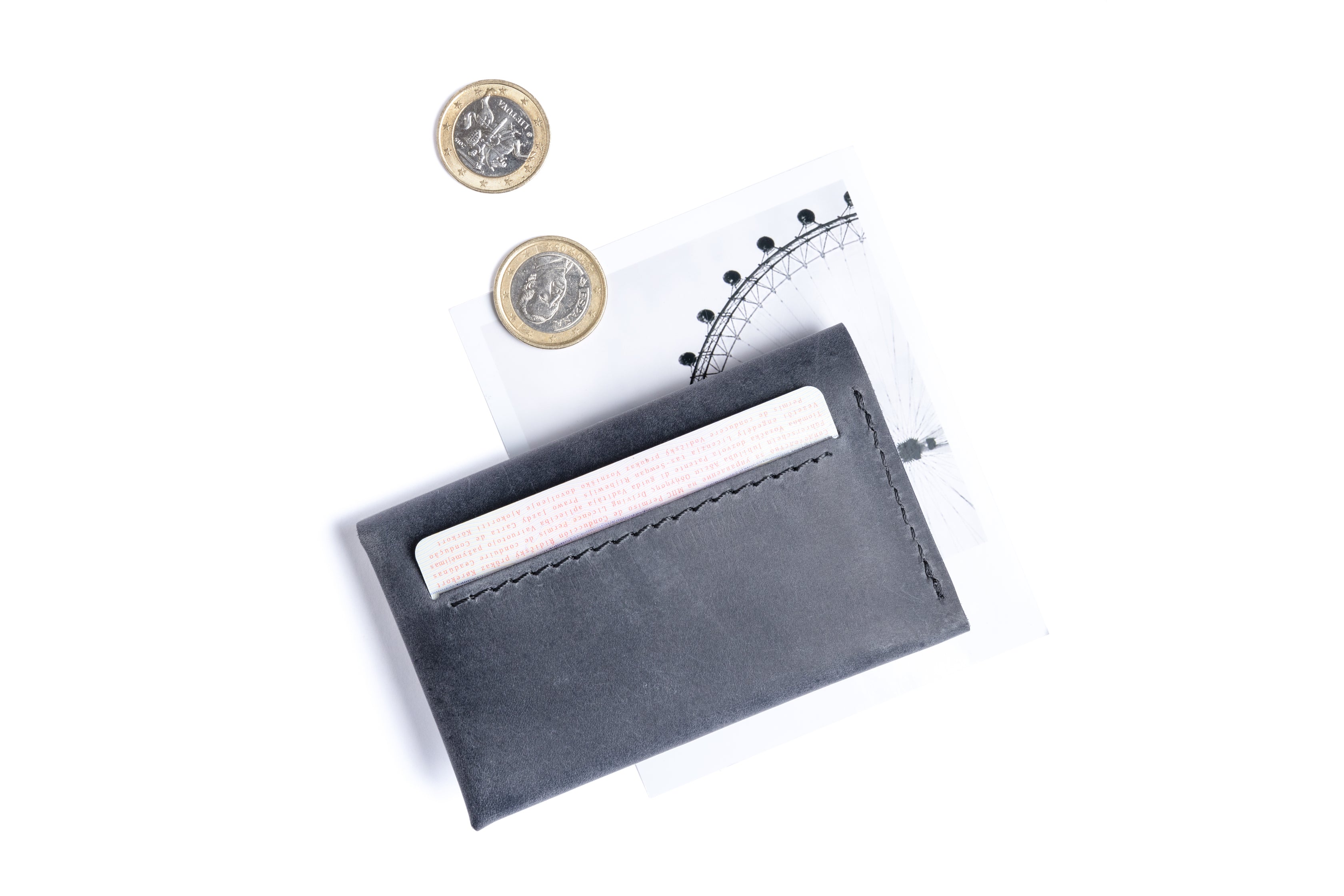 Small leather wallet for cards, coins and few folded bills.