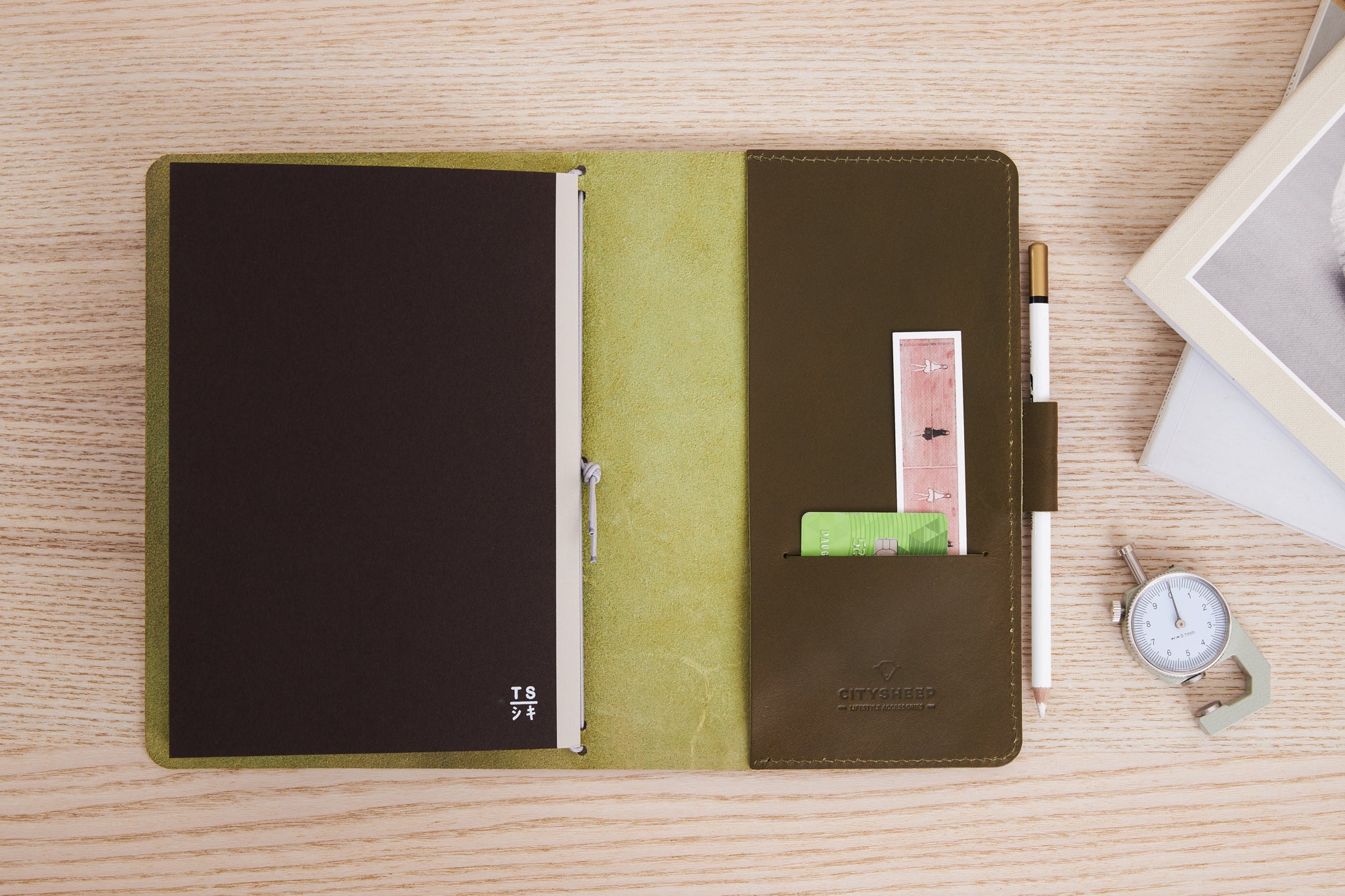 Journal Cover for Travelling in olive green leather with pockets and pen loop.