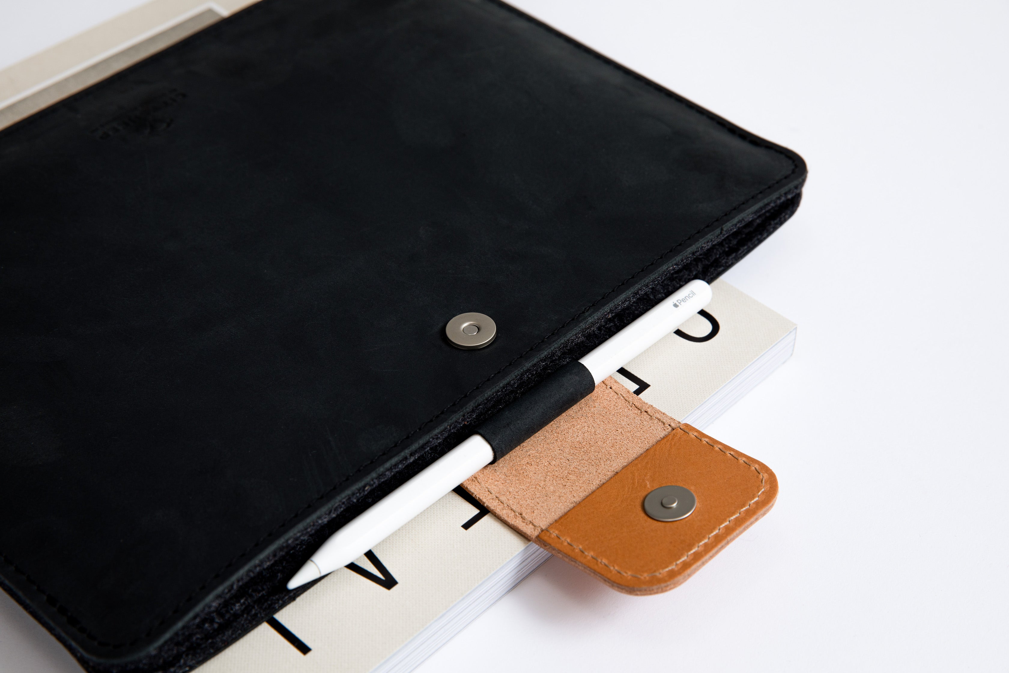 Protective full grain leather and merino wool felt iPad sleeve with Apple pencil holder.